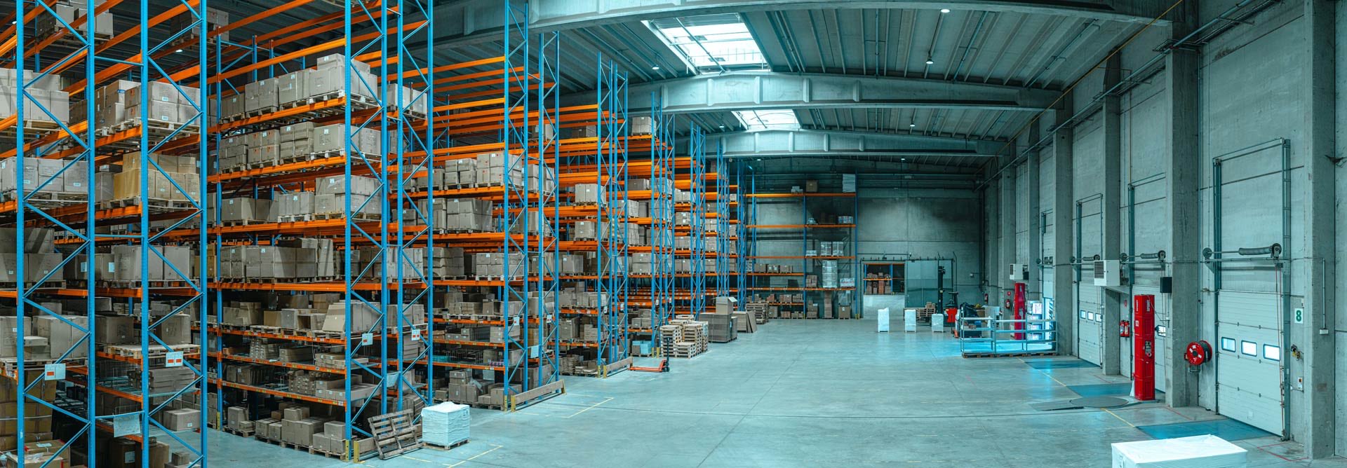 The inside of a modern fulfilment warehouse at night